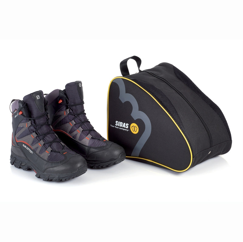 A black Sidas shoe bag with a yellow stripe, alongside a pair of hiking boots.
