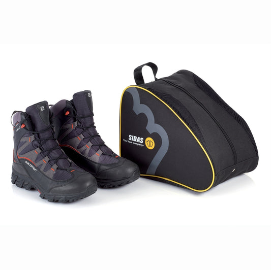 A black Sidas shoe bag with a yellow stripe, alongside a pair of hiking boots.