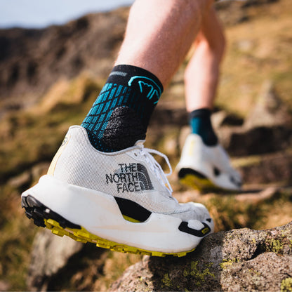 Josh wade wearing The North Face shoes and Sidas socks on a rocky trail