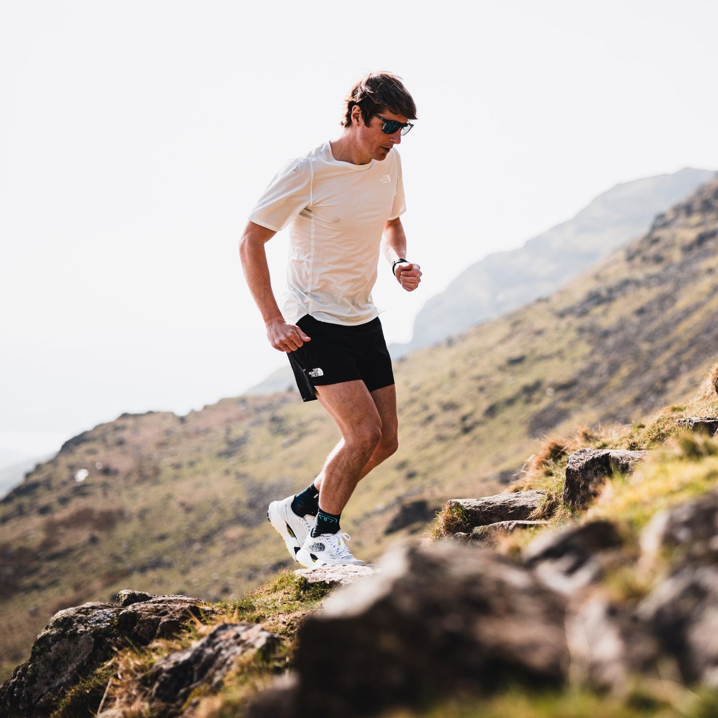Josh wade running on a mountain trail with scenic background