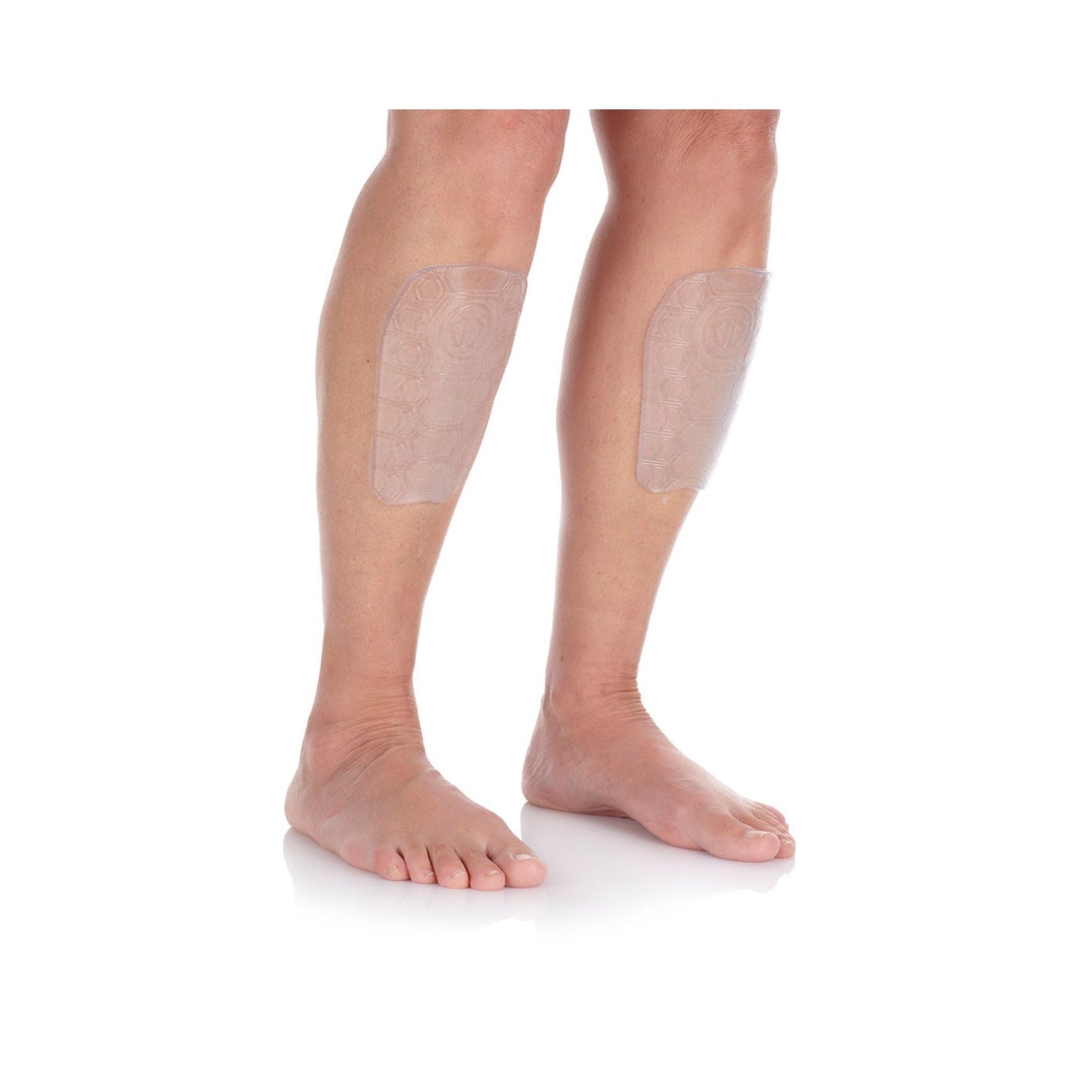 Transparent shin protectors on a person's legs with a white background