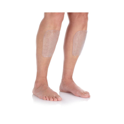 Transparent shin protectors on a person's legs with a white background