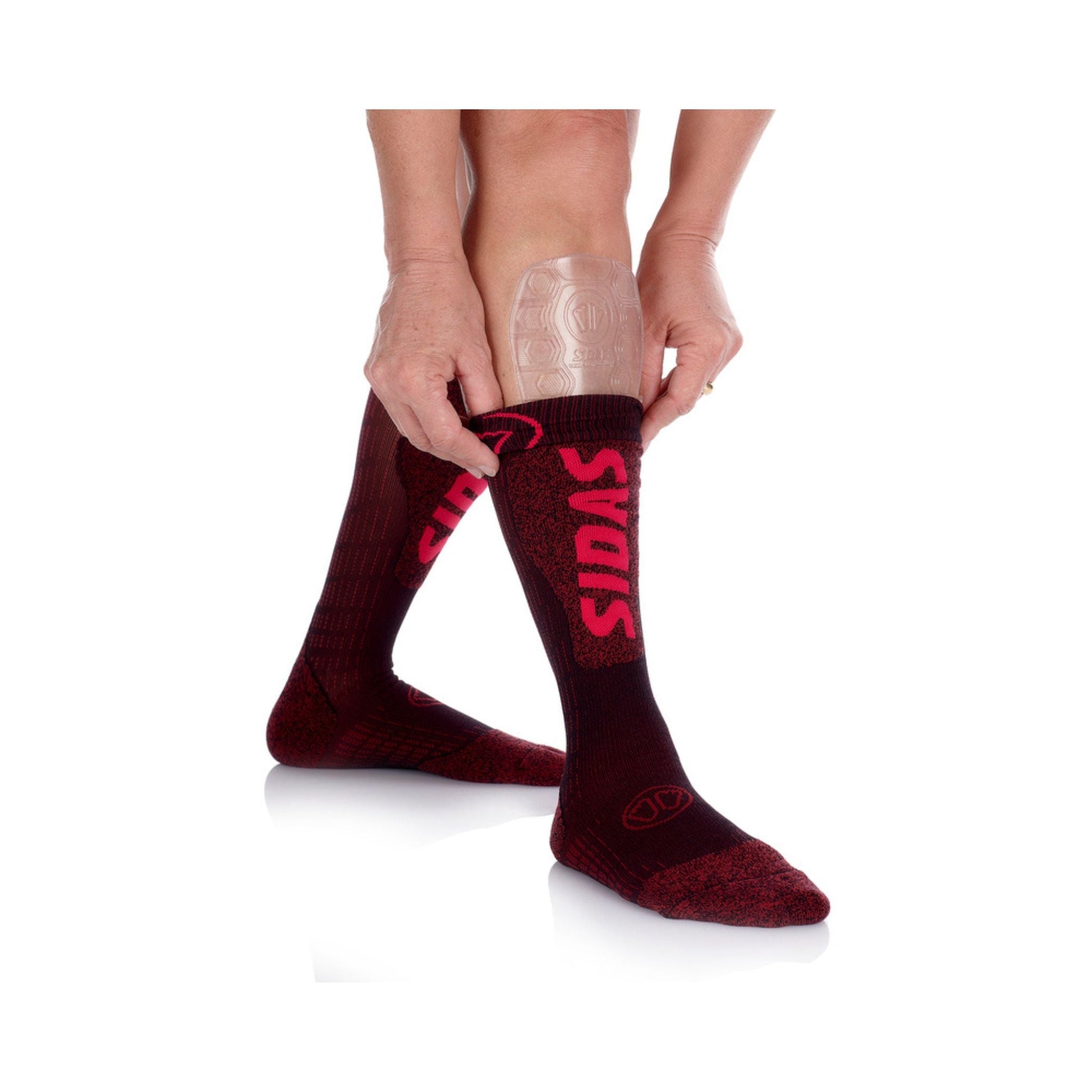 Person wearing shin protectors with maroon socks with red branding on a white background