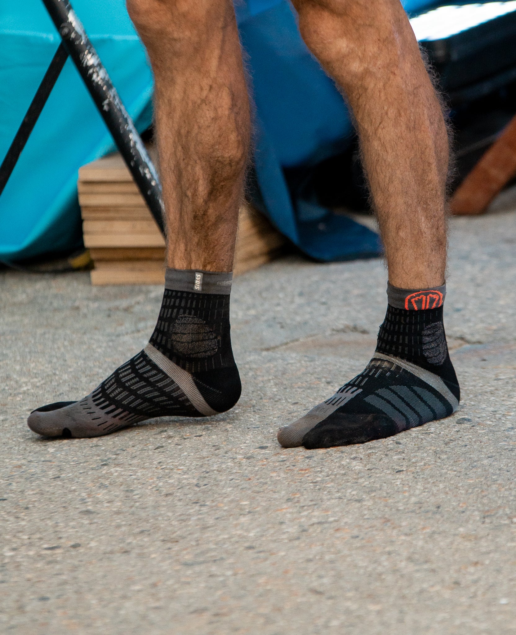 t-free trail running socks black grey being worn close up